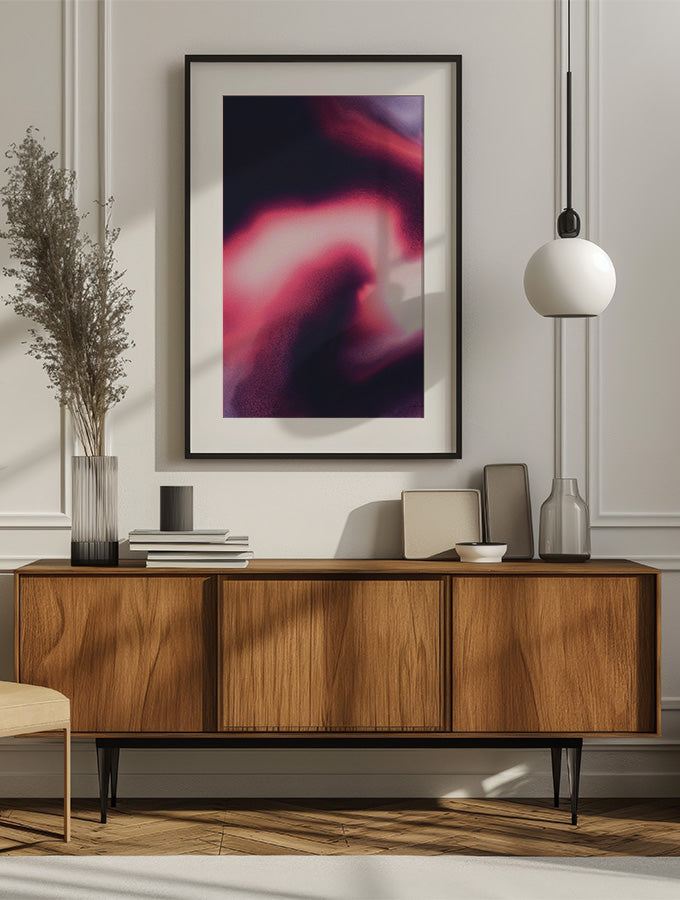 Framed contemporary abstract artwork "Becoming" from the Infinite Studio series by Nicole Potrich featuring magenta and black fluid marble-inspired abstraction symbolising transformation and emergence, mounted onwall in a cozy livingroom.